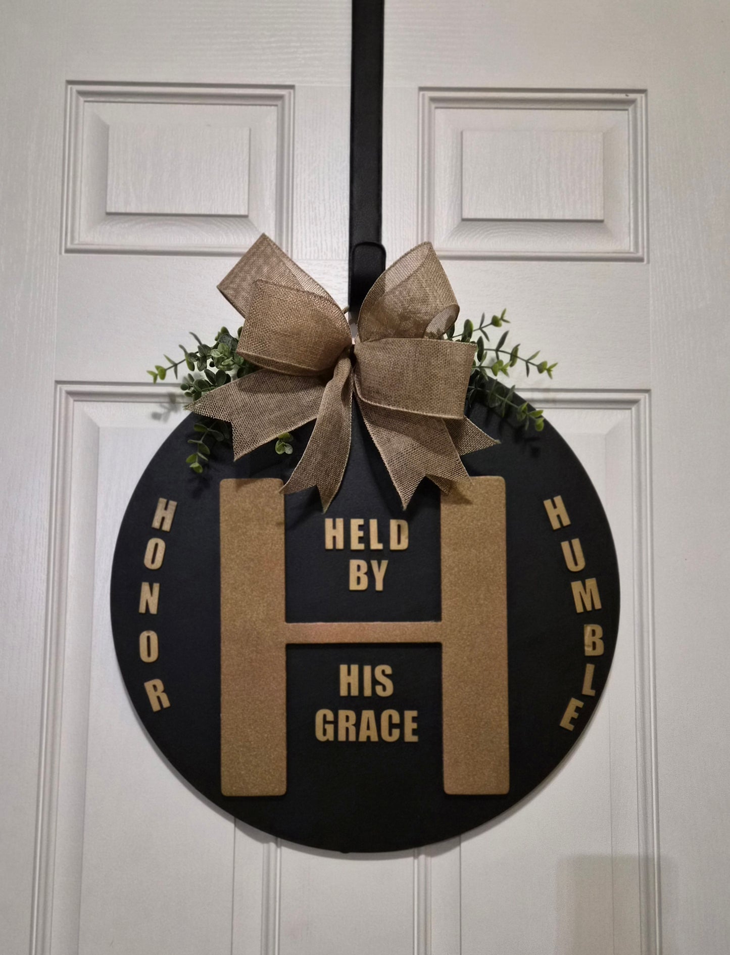 Held By His Grace Door Hanger – Faith-Inspired Décor with Gold & Black Design